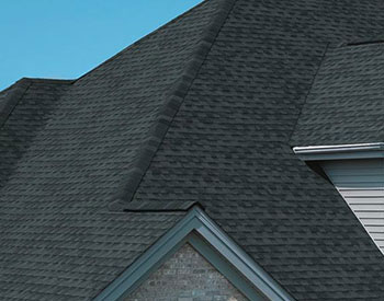 Close-up of the roof of a residential home with charcoal black GAF shingles